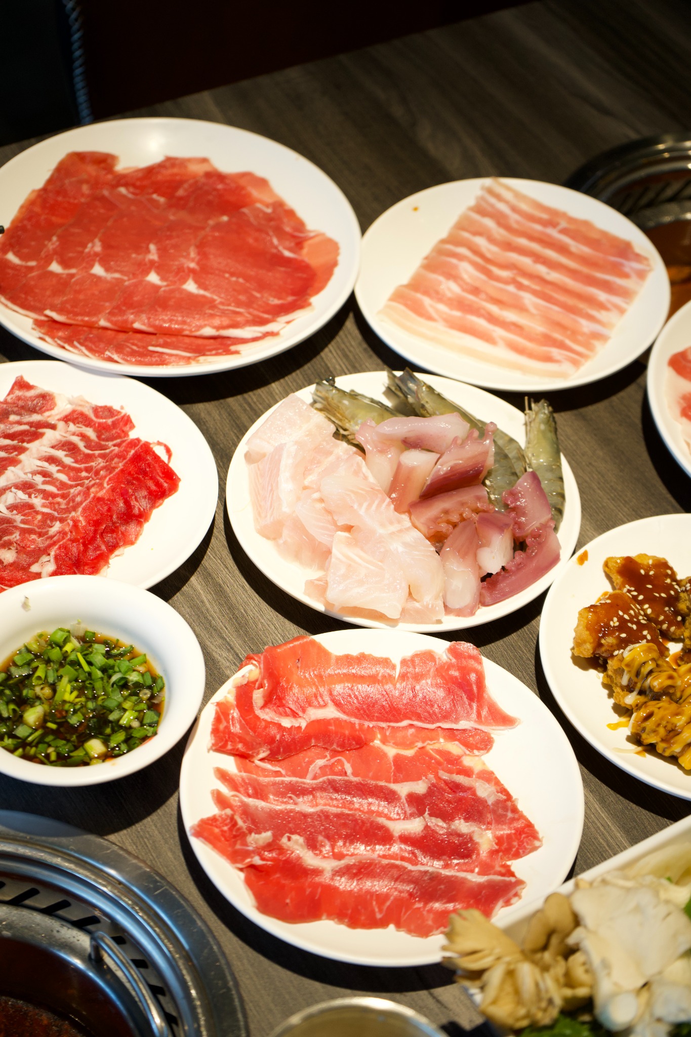 Hot pot buffet meat, seafood and sides spread